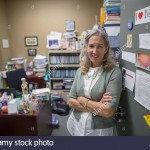 female-college-biology-professor-standing-in-doorway